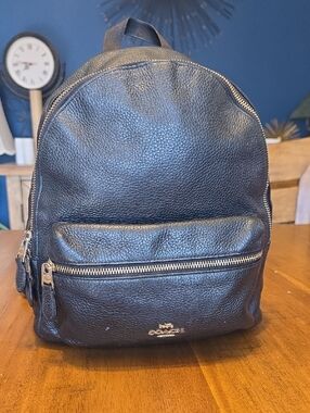 Coach Medium Charlie Backpack in black pebbled leather.
